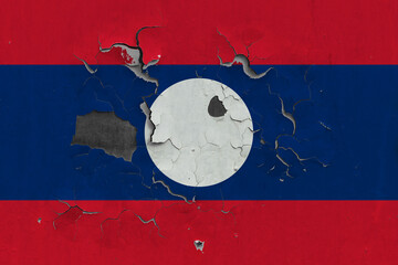 Laos flag close up old, damaged and dirty on wall peeling off paint to see inside surface. Vintage...