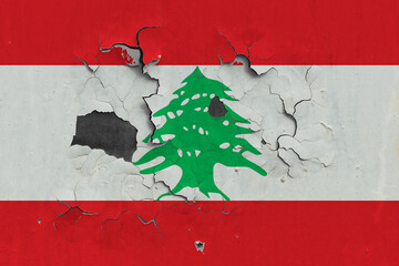 Lebanon flag close up old, damaged and dirty on wall peeling off paint to see inside surface. Vintage National Concept.