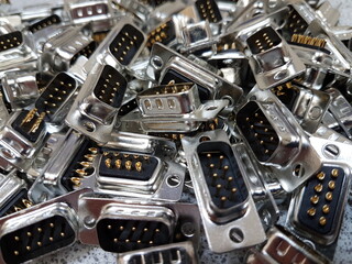 Close up view of a pile of 9 way connectors contacts 
