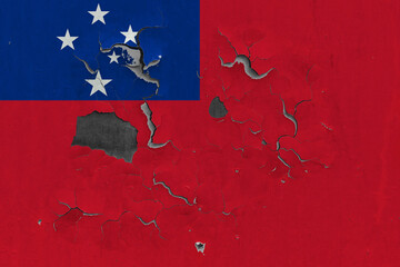 Samoa flag close up old, damaged and dirty on wall peeling off paint to see inside surface. Vintage National Concept.