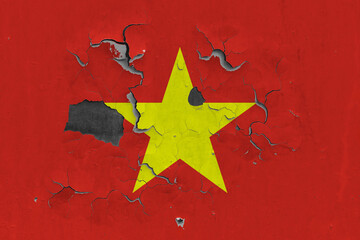 Vietnam flag close up old, damaged and dirty on wall peeling off paint to see inside surface. Vintage National Concept.