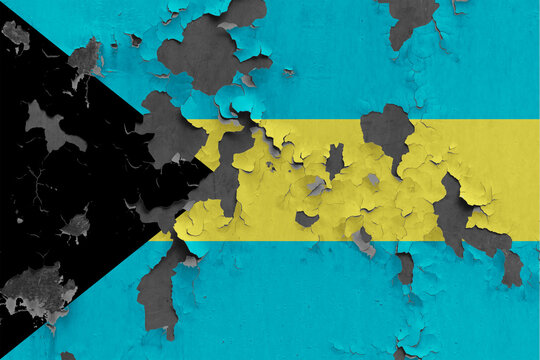Bahamas flag close up painted, damaged and dirty on wall peeling off paint to see concrete surface. Vintage National Concept.