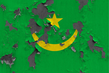 Mauritania flag close up painted, damaged and dirty on wall peeling off paint to see concrete surface. Vintage National Concept.