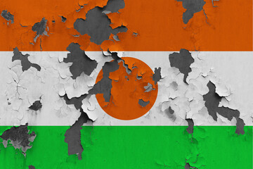 Niger flag close up painted, damaged and dirty on wall peeling off paint to see concrete surface. Vintage National Concept.