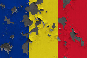 Romania flag close up painted, damaged and dirty on wall peeling off paint to see concrete surface....