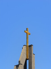 Golden cross on a top of christian gospel baptist church against the blue sky on a sunny day....