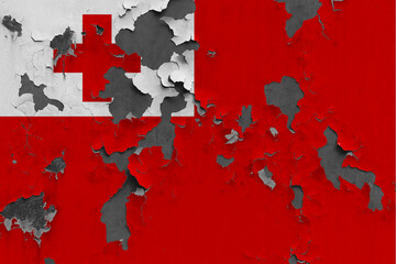 Tonga flag close up painted, damaged and dirty on wall peeling off paint to see concrete surface. Vintage National Concept.