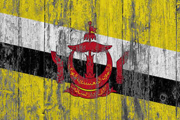 Brunei flag on grunge scratched wooden surface. National vintage background. Old wooden table scratched flag surface.