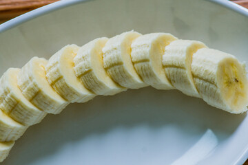 Sliced banana on white dish