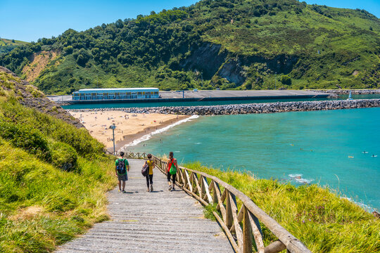 Three friends going down to Orio beach one June summer afternoon on the trail, gipuzkoa, basque country. Excursion from San Sebasti&aacute;n to the town of Orio through Mount Igeldo walking 3 friends.