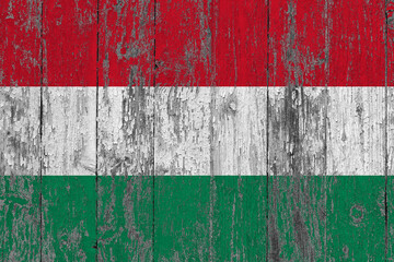 Hungary flag on grunge scratched wooden surface. National vintage background. Old wooden table scratched flag surface.