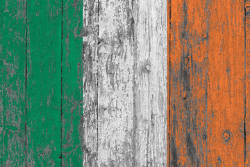 Ireland flag on grunge scratched wooden surface. National vintage background. Old wooden table scratched flag surface.