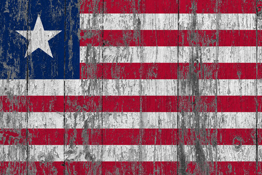 Liberia flag on grunge scratched wooden surface. National vintage background. Old wooden table scratched flag surface.