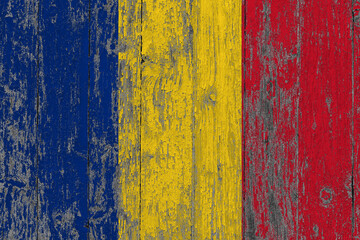 Romania flag on grunge scratched wooden surface. National vintage background. Old wooden table...