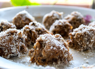 homemade sweets made from dried fruits and peanut butter sprinkled with coconut