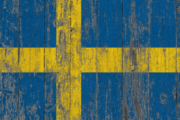 Sweden flag on grunge scratched wooden surface. National vintage background. Old wooden table scratched flag surface.