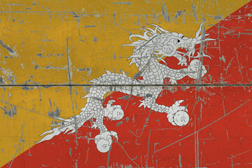 Bhutan flag painted on cracked dirty surface. National pattern on vintage style surface. Scratched and weathered concept.