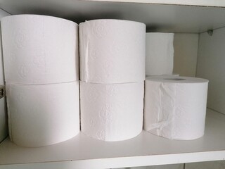 stack of toilet paper in a shelf