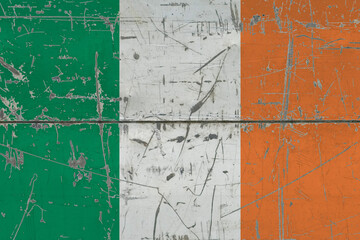 Ireland flag painted on cracked dirty surface. National pattern on vintage style surface. Scratched and weathered concept.