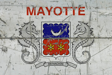 Mayotte flag painted on cracked dirty surface. National pattern on vintage style surface. Scratched and weathered concept.
