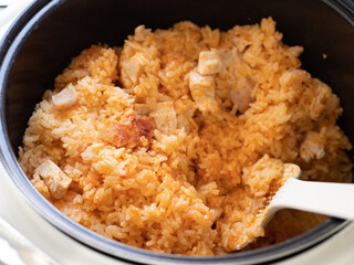Rice with turkey meat cooked in instant pot. Top view of ready-to-eat rice with sliced poultry and spices, in slow cooker or multi-cooker