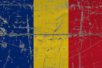 Romania flag painted on cracked dirty surface. National pattern on vintage style surface. Scratched and weathered concept.