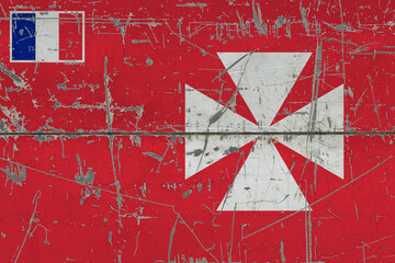 Wallis And Futuna flag painted on cracked dirty surface. National pattern on vintage style surface. Scratched and weathered concept.