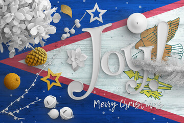American Samoa flag on wooden table with joy text. Christmas and new year background, celebration...