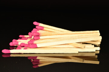 Matches made of wood, close-up, on a black background.
