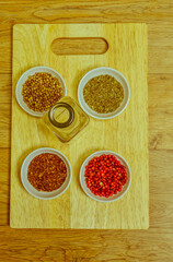 Obraz na płótnie Canvas Spices in white bowl on cutting board