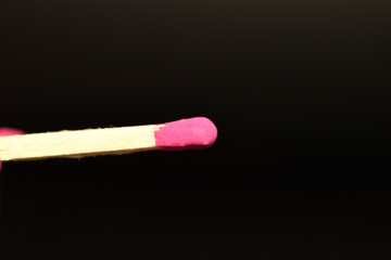 Matches made of wood, close-up, on a black background.