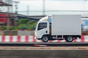 Motion image of a small white truck for road running transportation