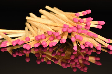 Matches made of wood, close-up, on a black background.