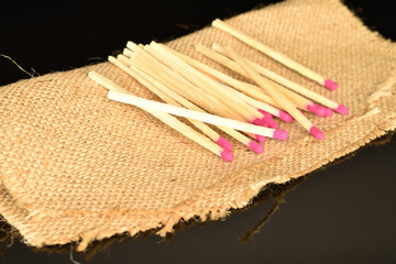 Matches made of wood, close-up, on a black background.
