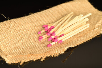 Matches made of wood, close-up, on a black background.