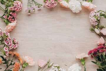 frame of flowers on wooden background
