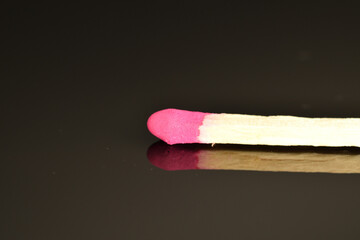 Matches made of wood, close-up, on a black background.