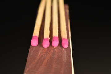 Matches made of wood, close-up, on a black background.