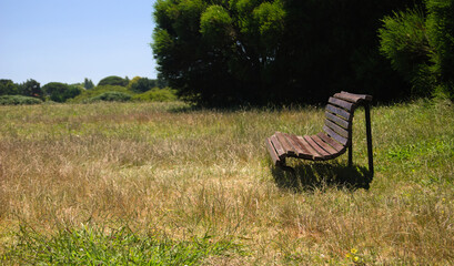 Banco de jardim instalado numa paisagem no meio do nada, campo aberto