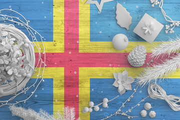 Aland Islands flag on wooden table with snow objects. Christmas and new year background,...