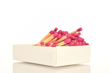Matches made of wood, close-up, on a white background.