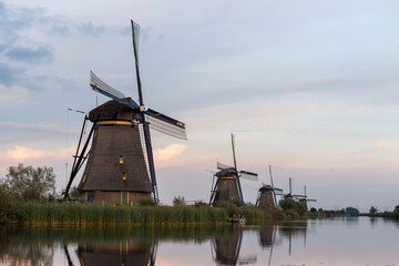 Naklejka premium windmills in the netherlands along a canal