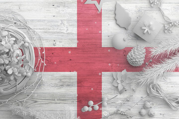England flag on wooden table with snow objects. Christmas and new year background, celebration national concept with white decor.