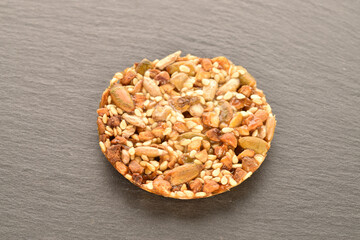 A few delicious walnut cookies, close-up, on a slate board.