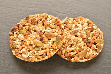 A few delicious walnut cookies, close-up, on a slate board.