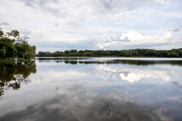 Beautiful clouds reflected on the blue lake surface