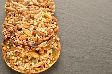 A few delicious walnut cookies, close-up, on a slate board.