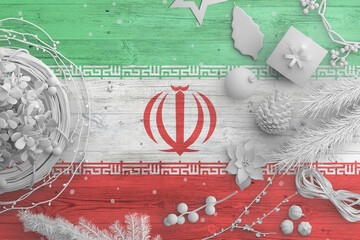 Iran flag on wooden table with snow objects. Christmas and new year background, celebration...