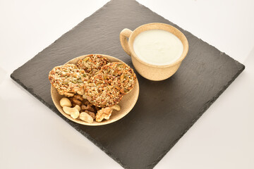 A few delicious walnut cookies, close-up, on a slate board.