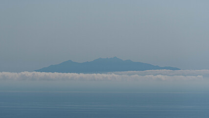 misty morning on Monte Cristo Island seen from Corsica